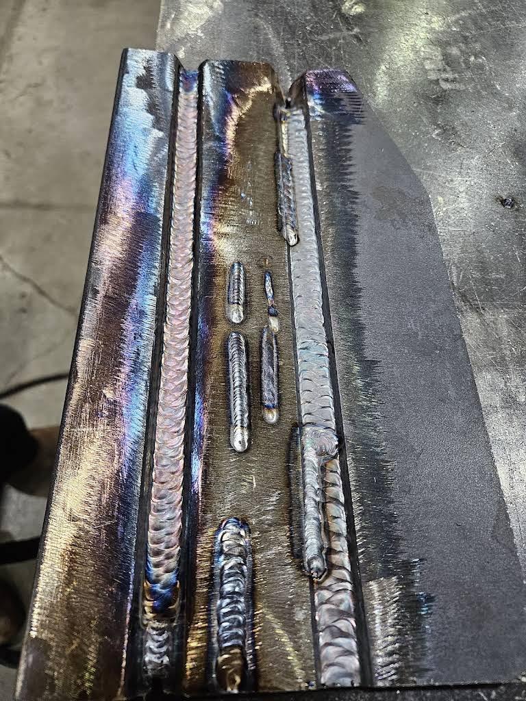 Close-up of metal weld beads on a steel piece.